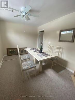 Toronto (Bathurst Manor) duplex for rent - A white dining table with four chairs and a ceiling fan in a room.