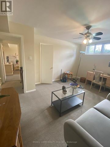 Toronto (Bathurst Manor) duplex for rent - A living room with a grey couch and a glass coffee table.