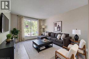 Cambridge apartment for rent - A living room with a grey couch, a coffee table, and a large window with curtains.