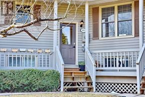 Blue Mountains townhouse for rent - A house numbered 106 has a grey facade and a wooden porch.