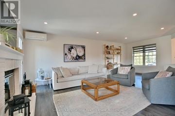 Blue Mountains townhouse for rent - A living room with a fireplace and a painting on the wall.