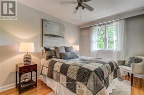 Toronto (The Beaches) apartment for rent - A bedroom with a bed, a ceiling fan, and a window.