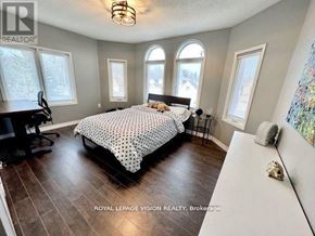 Richmond Hill (Westbrook) apartment for rent - A bedroom with a large bed and a desk with a chair.