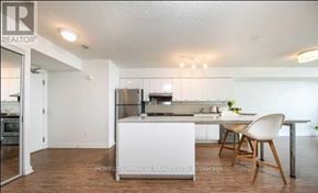 Toronto (Bayview Village) condo for rent - A kitchen with a white island and a wooden chair.