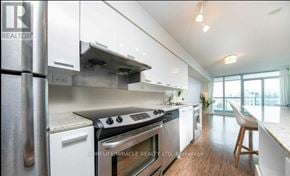 Toronto (Bayview Village) condo for rent - A modern kitchen with white cabinets and stainless steel appliances.