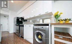 Toronto (Bayview Village) condo for rent - A modern kitchen with white cabinets and stainless steel appliances.