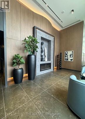 Pickering (Bay Ridges) condo for rent - A living room with a grey couch and a framed picture on the wall.