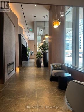 Pickering (Bay Ridges) condo for rent - A hallway with a Christmas tree and a sign that says "The Agency Brokerage".