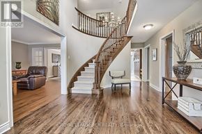 Newmarket (Stonehaven-Wyndham) apartment for rent - A spacious living room with a staircase and a wooden floor.