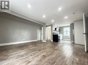 Windsor apartment for rent - A spacious room with wooden flooring and white walls.