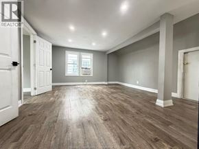 Windsor apartment for rent - A spacious room with wooden flooring and white walls.