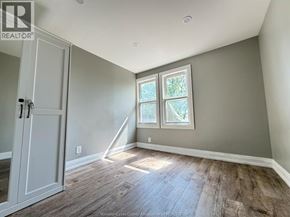 Windsor apartment for rent - A room with a wooden floor and a white door.