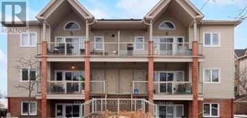 Ottawa condo for rent - A two-story apartment building with a balcony on the second floor.