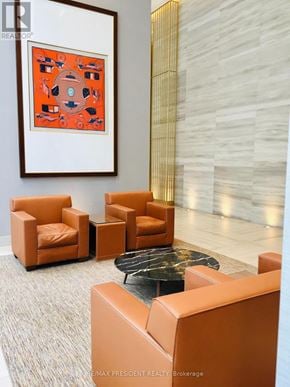 Toronto (Waterfront Communities) condo for rent - A living room with a grey carpet and a painting on the wall.