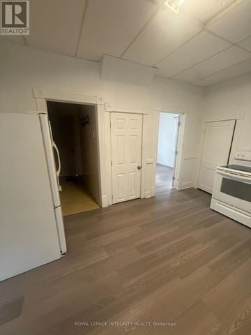 Cornwall multi-family for rent - A white refrigerator is in a kitchen with wood flooring.