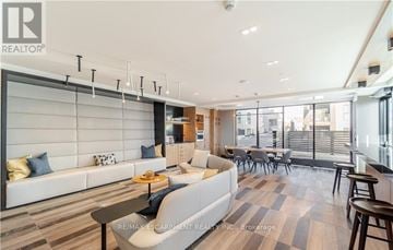 Oakville (Jm Joshua Meadows) condo for rent - A modern living room with a white sofa and a coffee table.