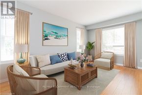 Hamilton (Binbrook) townhouse for rent - A living room with a sofa, armchair, and coffee table.