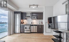 Toronto (Yonge-Eglinton) condo for rent - A modern kitchen with stainless steel appliances and wooden flooring.