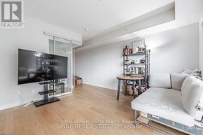 Toronto (Yonge-Eglinton) condo for rent - A living room with a television, a sofa, and a bookshelf.