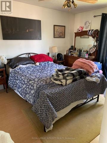 Ottawa apartment for rent - A bedroom with a bed, nightstand, and a painting on the wall.
