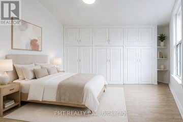 Toronto (Weston-Pellam Park) duplex for rent - A bedroom with a large bed, a nightstand with a lamp, and a painting on the wall.