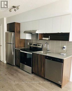 Burlington (Lasalle) condo for rent - A kitchen with wooden cabinets and stainless steel appliances.