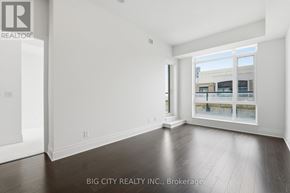 Markham (Unionville) condo for rent - A spacious room with a view of a building through the window.