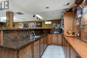 Mississauga (Lorne Park) apartment for rent - A kitchen with wooden cabinets and a marble countertop.
