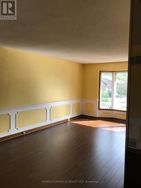 Mississauga (Lorne Park) apartment for rent - A room with wooden floors and yellow walls.