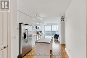 Toronto (Bay Street Corridor) condo for rent - A modern kitchen with stainless steel appliances and a view of the city.