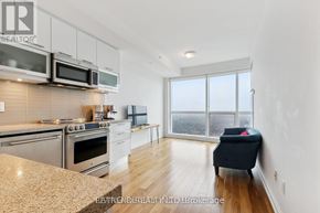 Toronto (Bay Street Corridor) condo for rent - A modern kitchen with stainless steel appliances and a view of the city.