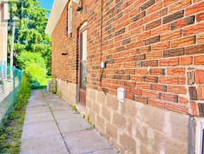 Toronto (Willowdale East) apartment for rent - A brick building with a fence and a sidewalk in front.
