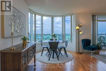 Toronto (Willowdale East) condo for rent - A dining room with a view of the ocean through large windows.
