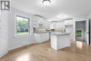 Simcoe apartment for rent - A well-lit, spacious kitchen with white cabinets and a central island.