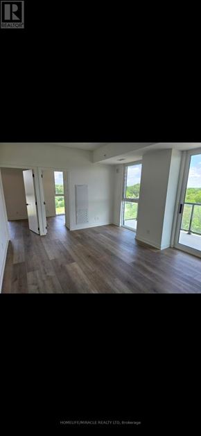 Brantford condo for rent - A room with wooden flooring and white walls.