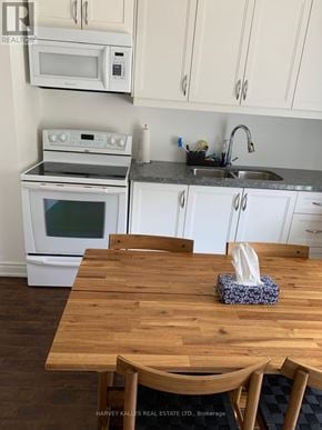 Newmarket (Woodland Hill) apartment for rent - A kitchen with a wooden table and white cabinets.