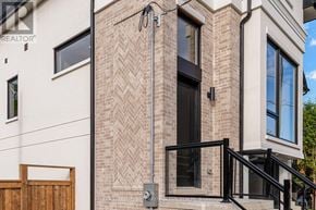 Mississauga (Port Credit) apartment for rent - A modern house with a brick facade and a black door.