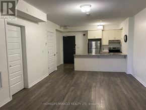 Markham (Cornell) condo for rent - A spacious kitchen and living room with wood flooring and white walls.