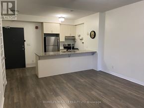 Markham (Cornell) condo for rent - A kitchen with a stainless steel refrigerator and a clock on the wall.