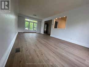 Richmond Hill (Crosby) apartment for rent - A spacious room with wooden flooring and white walls.