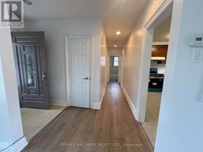 Richmond Hill (Crosby) apartment for rent - A hallway with a wooden floor and white walls.