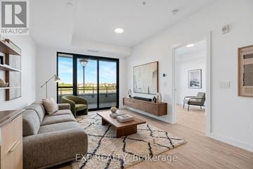 Milton (Cb Cobban) condo for rent - A living room with a grey couch and a coffee table.