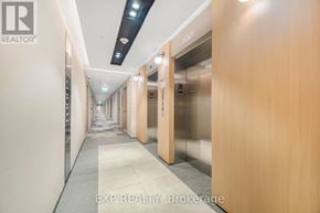 Milton (Cb Cobban) condo for rent - A long hallway with elevators on both sides.