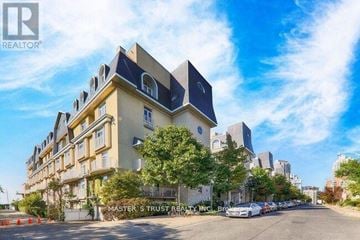 Toronto (Niagara) townhouse for rent - A street view of a building with the sign "MASTER & TRUST REALTY INC." on it.