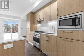 Toronto (Yonge-Eglinton) condo for rent - A modern kitchen with wooden cabinets and stainless steel appliances.