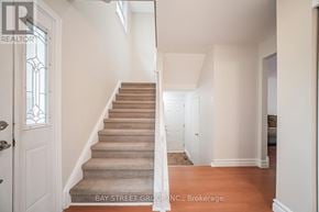 Oshawa (Eastdale) apartment for rent - A staircase with a carpeted runner and white walls.