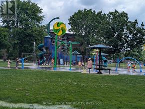 Welland (Prince Charles) condo for rent - A playground with a green slide and a yellow and green sign.