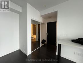 Toronto (Mount Pleasant West) condo for rent - A room with a black door and a mirror on the wall.