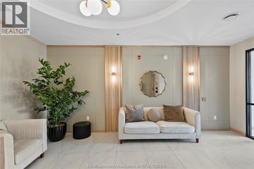 Chatham apartment for rent - A living room with a white couch and a round mirror on the wall.