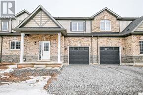 Fort Erie (Crescent Park) house for rent - A house with a garage and a driveway in front.